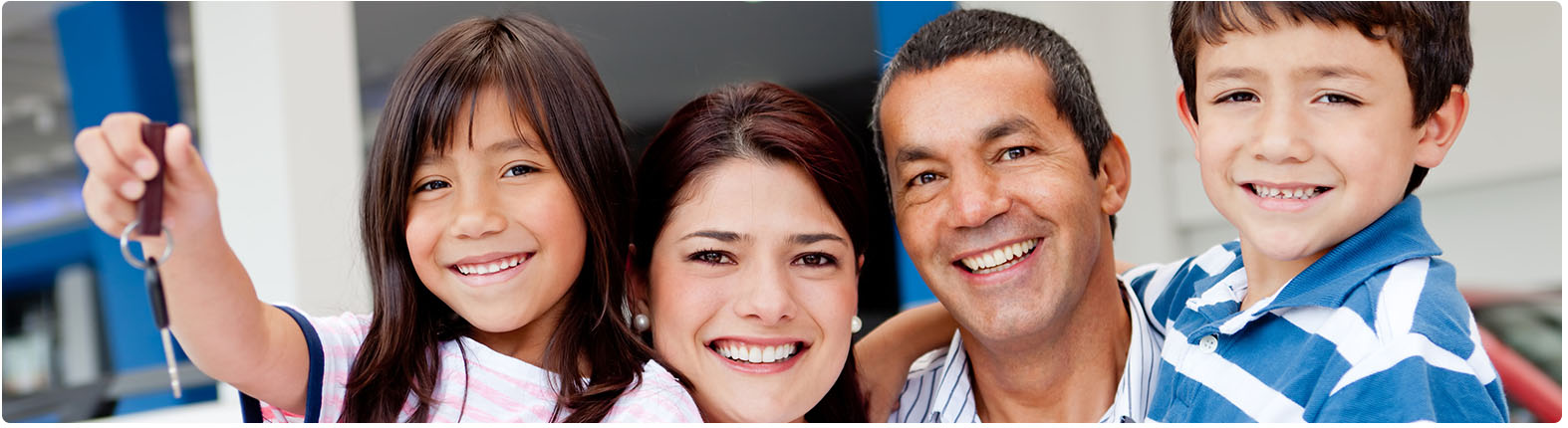 Family holding car keys of new car