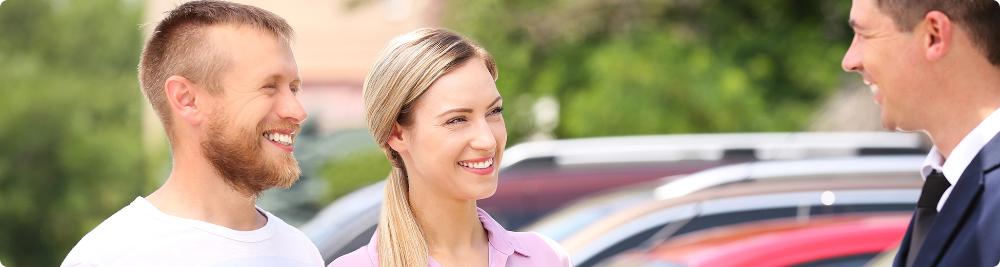 happy couple at car dealership