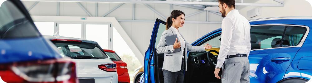 car dealer shows customer a car