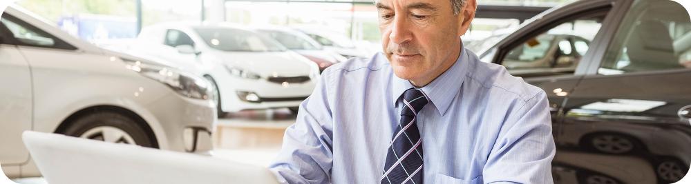 car dealer works at computer