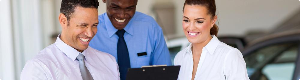 happy car dealership staff smile with each other