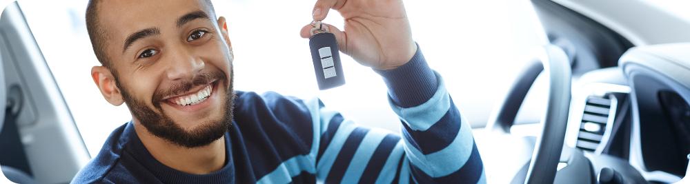 man holds car key inside vehicle