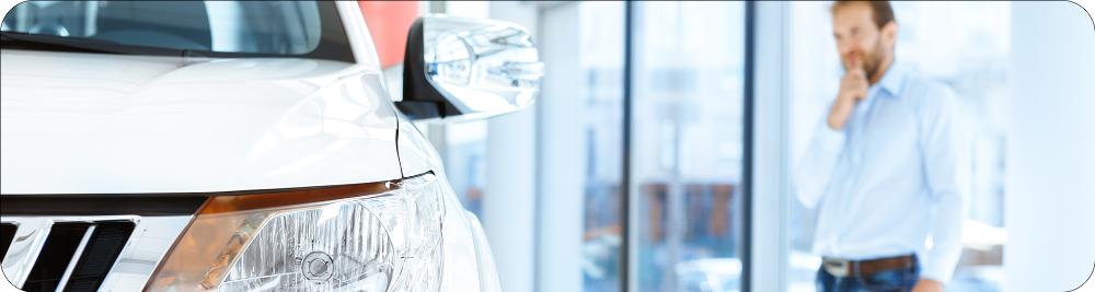 man looks at car he is considering