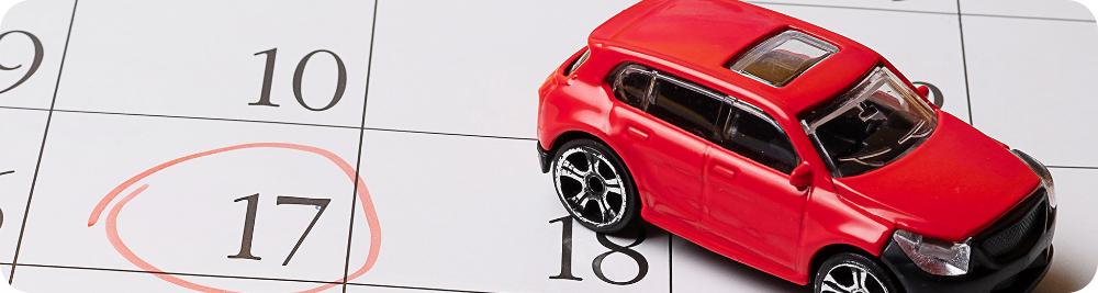 toy car on calendar with payment date circled